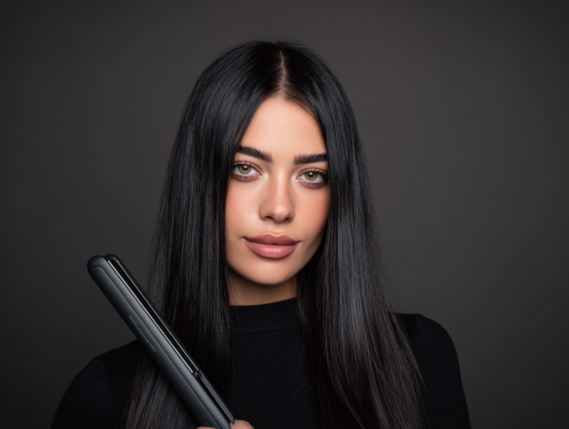 Elegant Woman with Hair Straightener